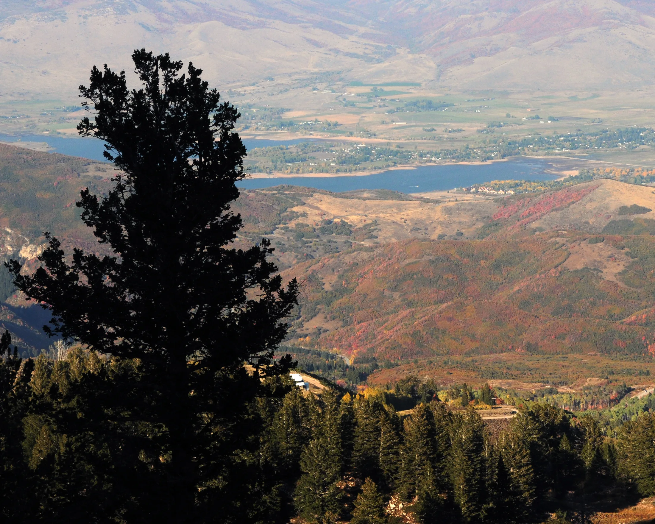 Pineview Reservoir and Ogden Valley surrounded by mountain ridges and autumn trees
